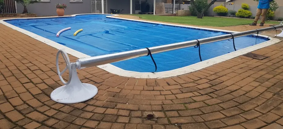 Solar pool blanket storage roll-up station